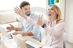 Successful two colleagues are expressing positive emotions