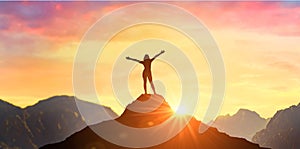 Successful woman has achieving new peak of personal growth and development. Woman on mountain peak with open arms welcoming new