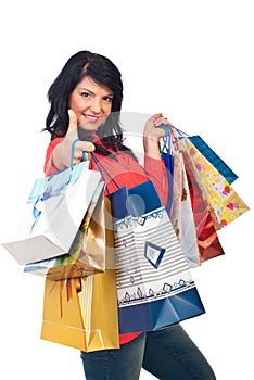 Successful woman at shopping give thumbs