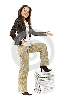 Successful woman standing on the pile of files