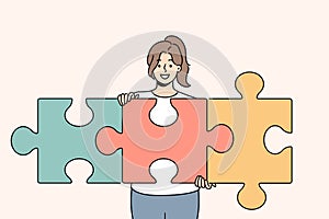 Successful woman unraveling puzzle and solving complex task while developing own startup