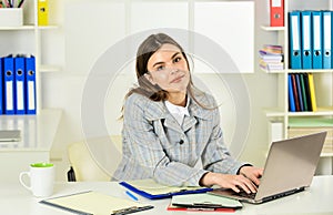 Successful woman work online on computer. confident office worker. secretary with document folder. formal fashion style