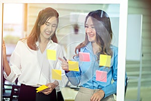 Successful women startuppers discussing plan together for work smiling and gesturing, happy women having friendly conversation