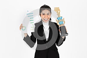 Successful young Asian business woman celebrating with trophy award over white isolated background. Success achievement in