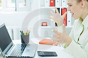 Successful young atractive woman looking on a laptop.