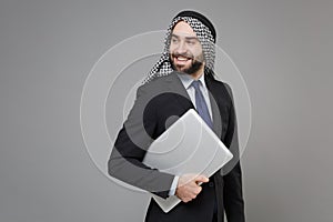 Successful young bearded arabian muslim businessman in keffiyeh kafiya ring igal agal classic black suit  on