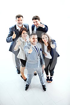 Successful young business people showing thumbs up