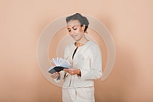 Successful young business woman with hands folded smiling over grey background