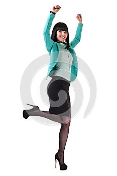 Successful young business woman happy for her success jumping. Isolated full body image on white background.