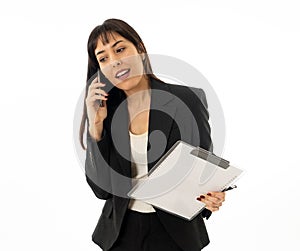 Successful young business woman talking on phone holding a folder. Isolated on white background