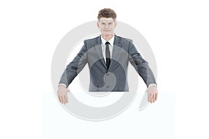 Successful young businessman with blank banner.isolated on a white