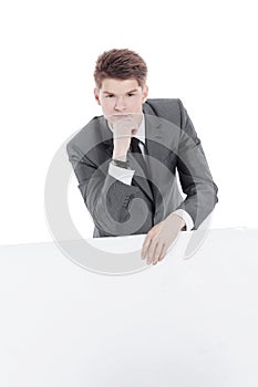 Successful young businessman with blank banner.isolated on a white