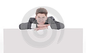 Successful young businessman with blank banner.isolated on a white