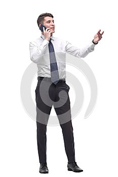 Successful young businessman talking on mobile phone. isolated on white