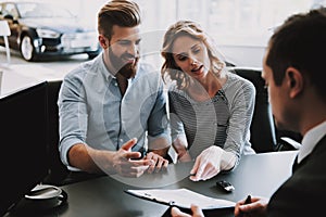 Successful Couple Talk to Car Seller in Office