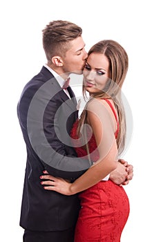 Successful young elegant couple kissing