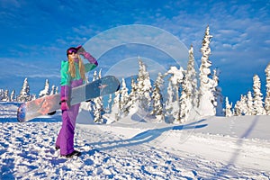 Successful young girl snowboarding in the mountains Sheregesh. Snowboarder resting. Stylish caucasian snowboarder. Snowboarder