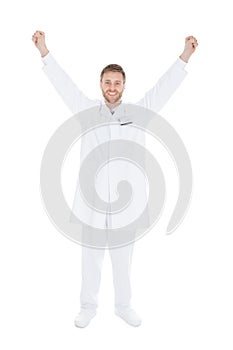 Successful Young Male Doctor With Arms Raised