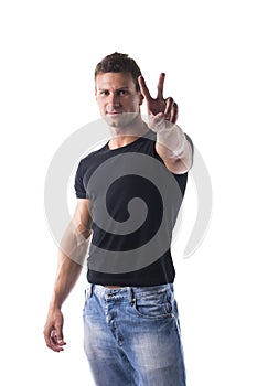 Successful young man doing Victory sign with fingers
