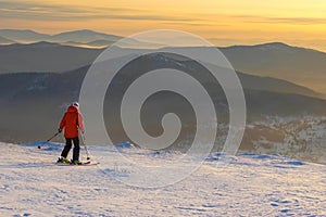 Successful young man skiing in the mountains Sheregesh. Skier resting on mountain top. Caucasian Skier on a background of sky .
