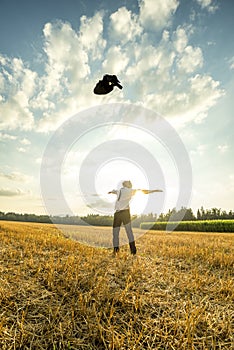 Successful Young Man Throwing his Coat in the Air