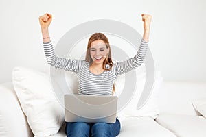 Successful young woman with notebook on a sofa