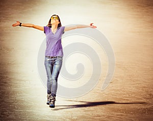 Successful young woman skating outdoor at Medeo, Almaty
