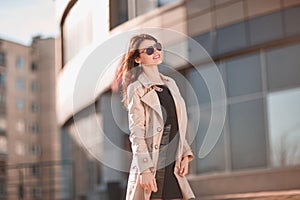 Successful young woman standing on the street near the office building