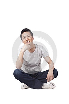 Successful youngman sitting on floor