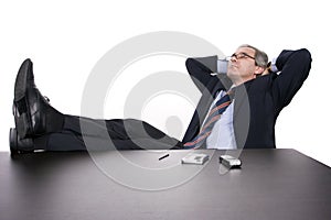 Successfull businessman relaxing over his desk