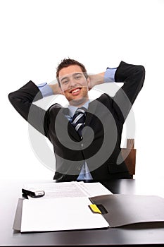 Successfull businessman relaxing over his desk