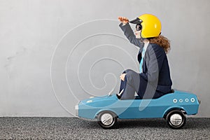 Successfull businesswoman driving toy car outdoor