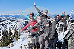 Successfull group of friends on mountain top.