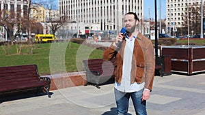 Successfull news reporter with microphone in hand talking live on the street