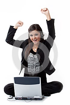 Successfull young woman by the computer on the flo
