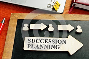 Succession planning concept. Wooden figures and arrows photo