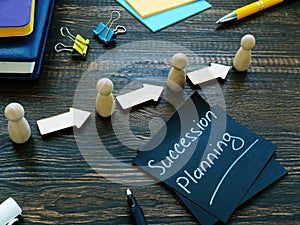 Succession planning and figurines with arrows. photo