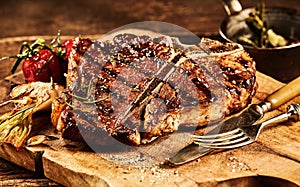 Succulent grilled t bone steak with fork and knife photo