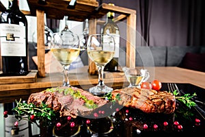 Succulent grilled tomahawk beef steak on the bone with red wine, seasonings, fresh rosemary