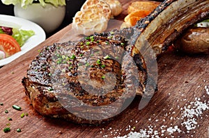 Succulent grilled tomahawk beef steak photo