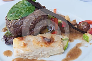 Succulent thick juicy portions of grilled fillet steak served with tomatoes and vegetables