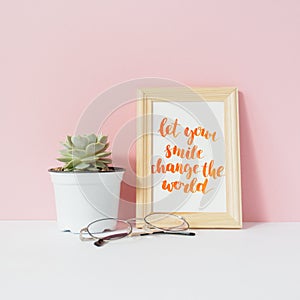 Succulent in white pot, eyeglasses, card with inspiration quote