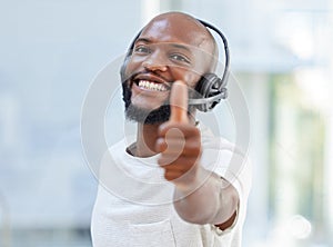Such a good day is deserves a thumbs up. a young businessman working in a call center.