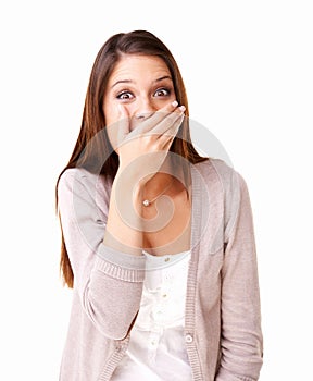 This is such a surprise. Surprised young woman covering her mouth against a white background.