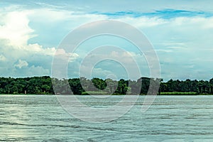 Such a wonderful landscape. Lake with green fields, blue sky, and clouds