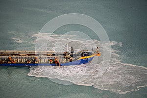 Suction Dredger Emptying Sluices, Spoiling Water of Gulf with mud Spot, Pollution, brown Muddy water - aerial shot