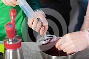 Suction of souce into culinary syringe