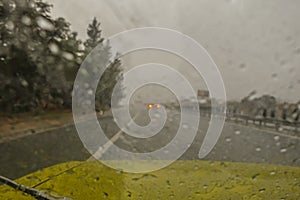 Sudden storm as seen through a windscreen of a car driving along a motorway