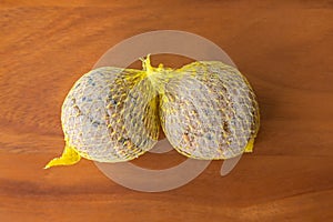 Suet treats, bird food in meshed bag full of nuts sunflower see photo