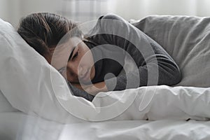 Suffer from depression , mental health problem. asian young woman sitting on the bed feeling depressed